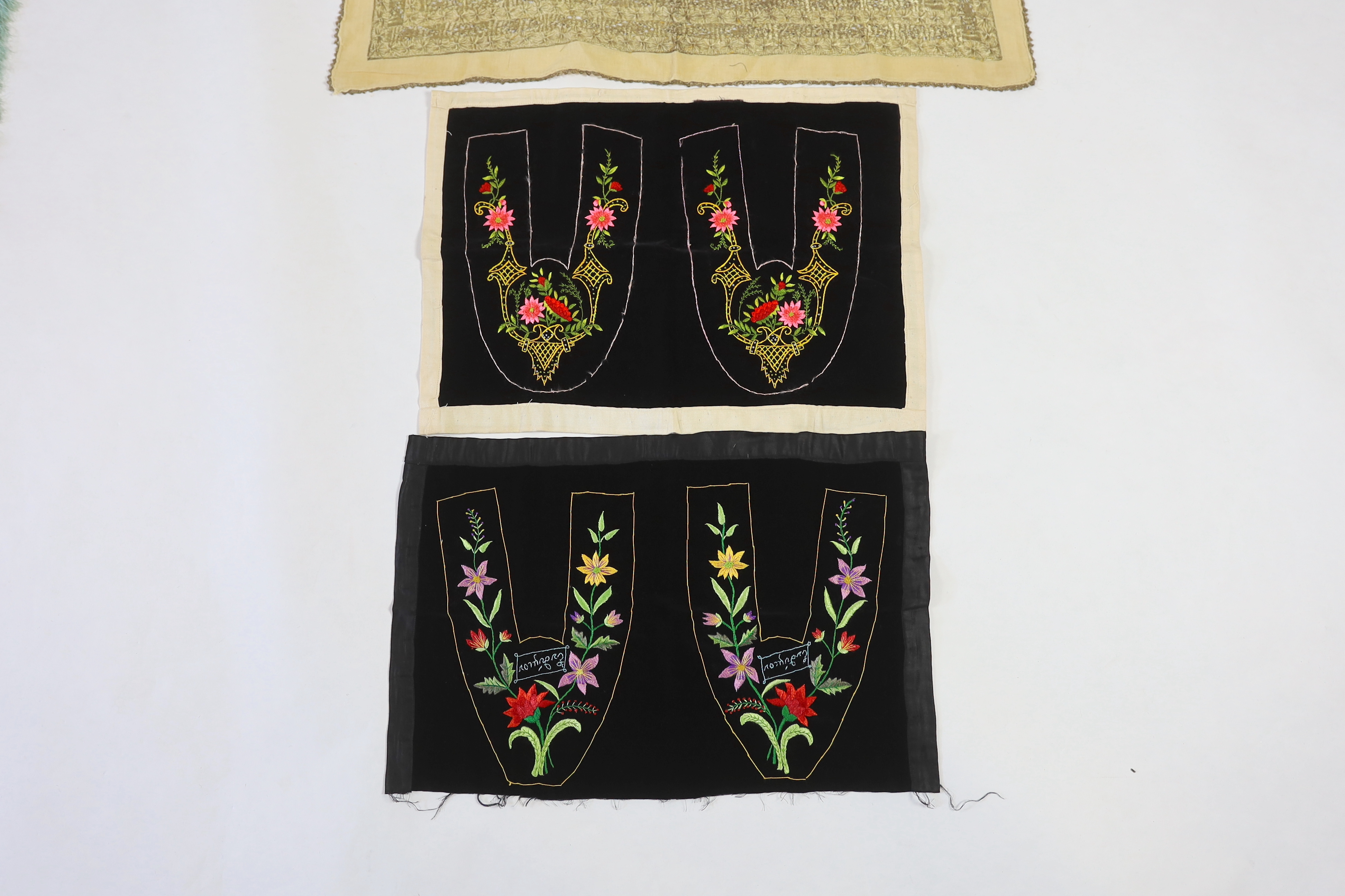 Two pairs of late 19th century black velvet silk embroidered slipper fronts (uncut), together with a cotton gold thread embroidered cloth, cloth 82cm square
